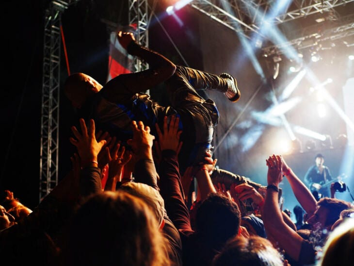 Stagediver wird von Konzertpublikum durch die Menge getragen Festival-Tipps und Festival-Packliste: Alles für das nächste Festival!