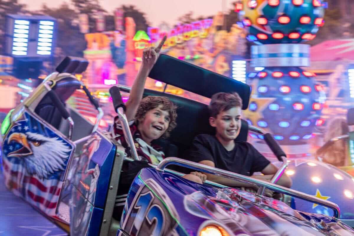 Zwei Jungs lachen auf bunter Karussellfahrt bei Nacht Unbeschwerte Stunden auf dem Wolfhager Kram- und Viehmarkt | (c) Stadt Wolfhagen