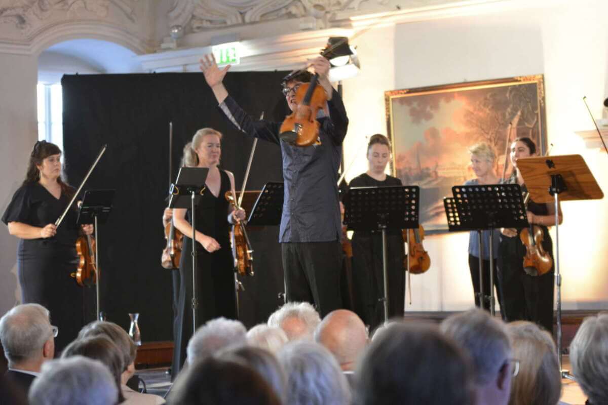 Konzert beim Via Nova Kunstfest 2025 im Schloss Corvey (UNESCO-Weltkulturerbe, Höxter) mit Hugo Ticciati und dem Modernt Orchestra. Auf der Bühne stehen Instrumente wie Violine, Cello und Klavier. Der prunkvolle Saal ist mit Gemälden verziert, das Publikum sitzt aufmerksam und verfolgt die Aufführung OModernt-Kammerorchester-Hugo-Ticciati-29.08.25-c-Ernst-Ehlert.jpg
1. September 2025
